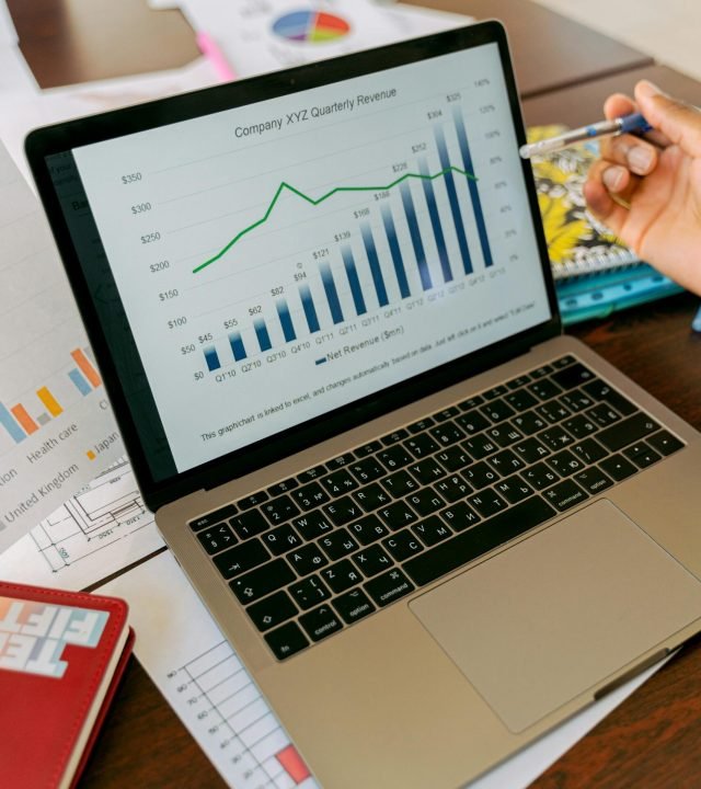 A close-up view of a laptop displaying business analytics and revenue charts.